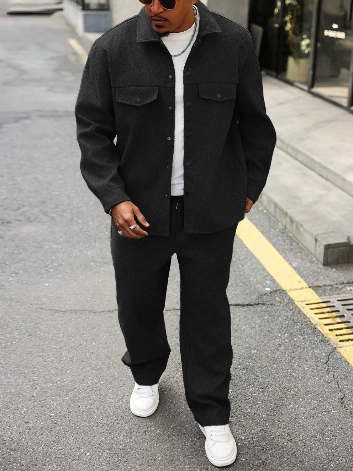 mens cargo jacket and pants set featuring a black button-up jacket with two chest pockets and a collar worn over a white t-shirt.