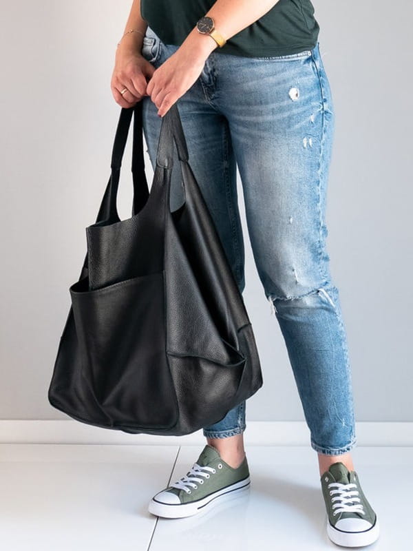 Black leather tote bag with two handles and a front pocket large capacity soft slouchy shoulder bag.