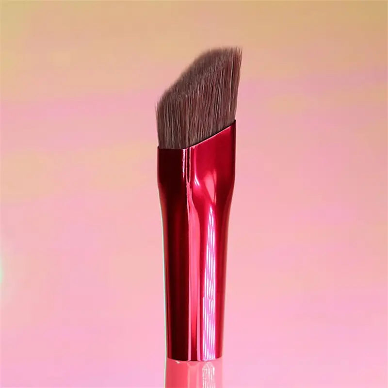 A sleek red metallic angled eyebrow and concealer makeup brush with dense brown bristles.