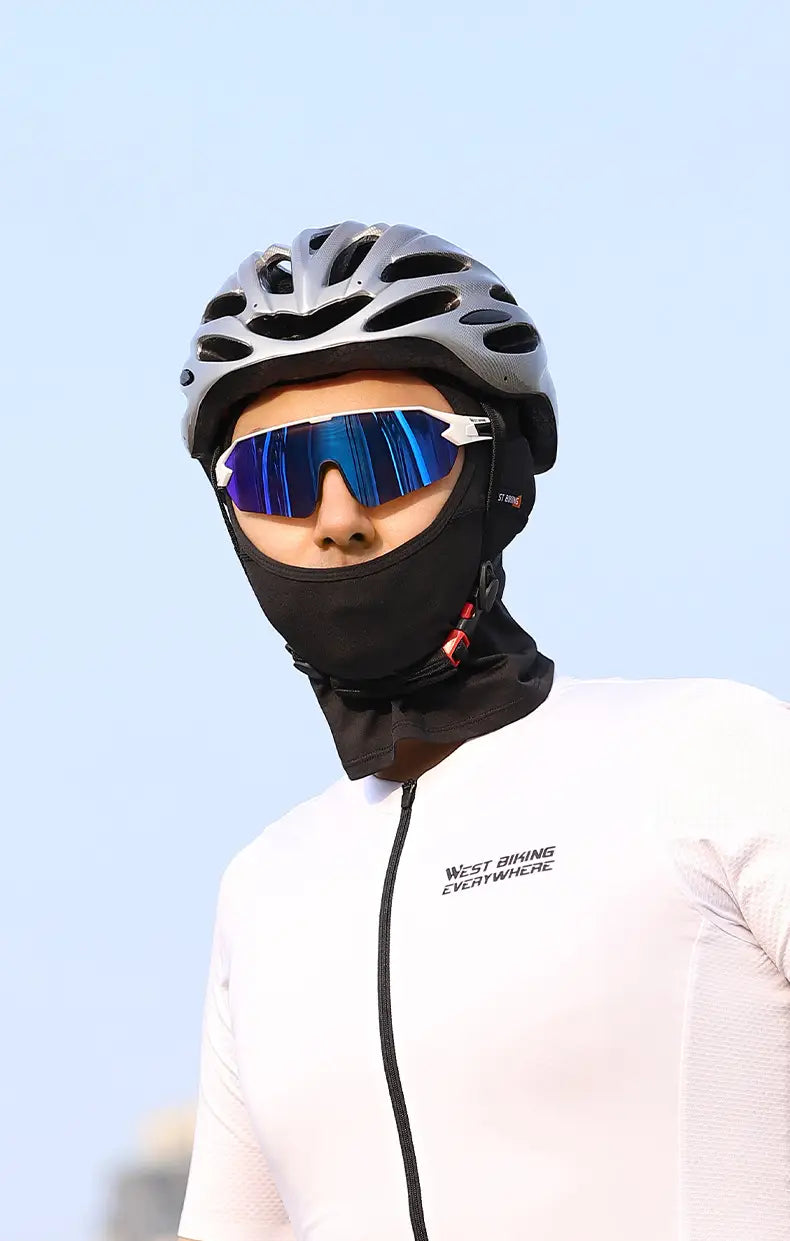 Silver aerodynamic cycling helmet with black ventilation slots and matte finish shown alongside a neon green cycling balaclava sun protection mask.