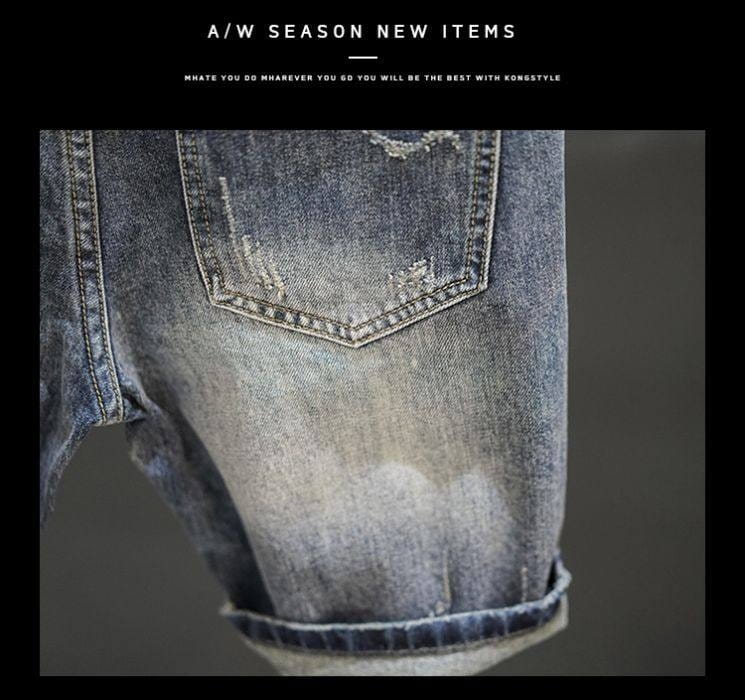 Distressed maple leaf denim shorts featuring a faded blue wash and frayed hem in distressed denim material.