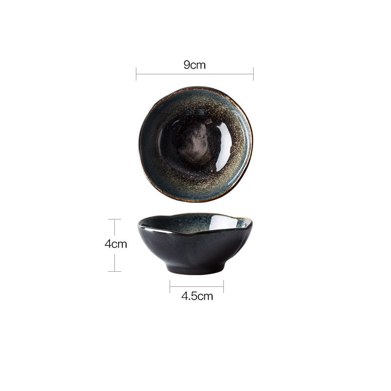 A glossy black ceramic bowl with a speckled iridescent glaze and scalloped rim from the ceramic tableware set black and gold kiln glaze porcelain.