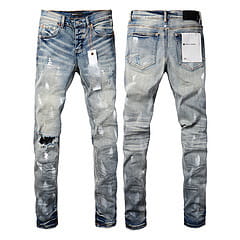 Men’s distressed slim fit patchwork denim jeans in blue with ripped knees and faded wash made from denim material.