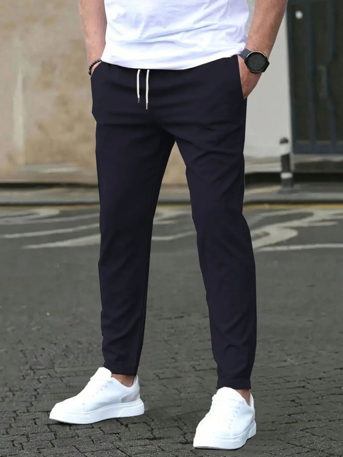black slim fit tapered jogger pants with white drawstring cord and tapered legs suitable for casual wear