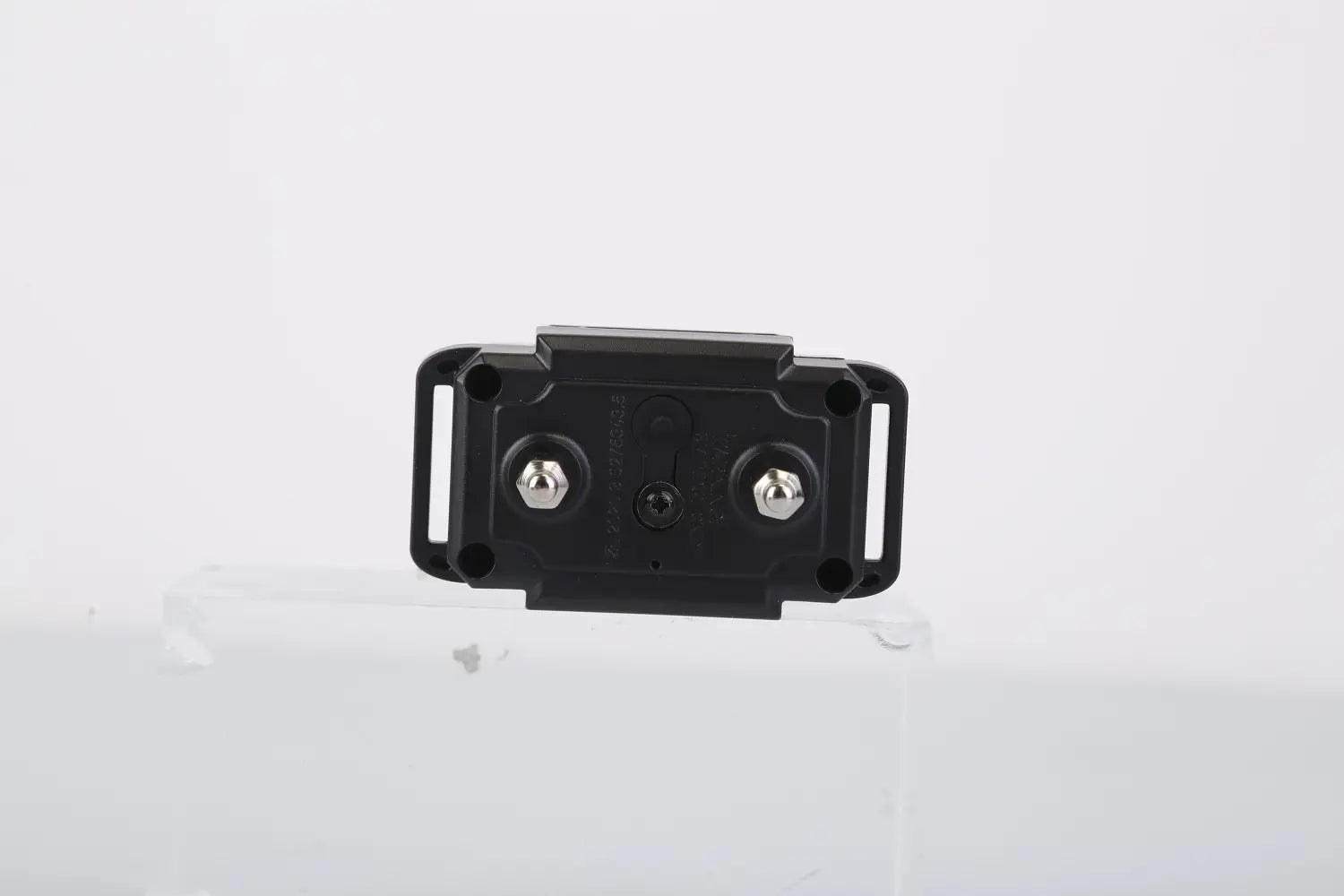black plastic remote of rechargeable smart dog bark collar with dual training modes featuring two silver screws and a central hole on the back side.