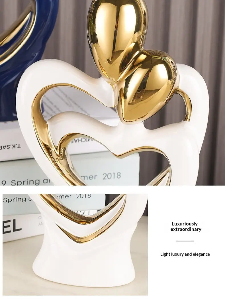 White ceramic abstract heart figurine with gold heart accents for modern home decor.