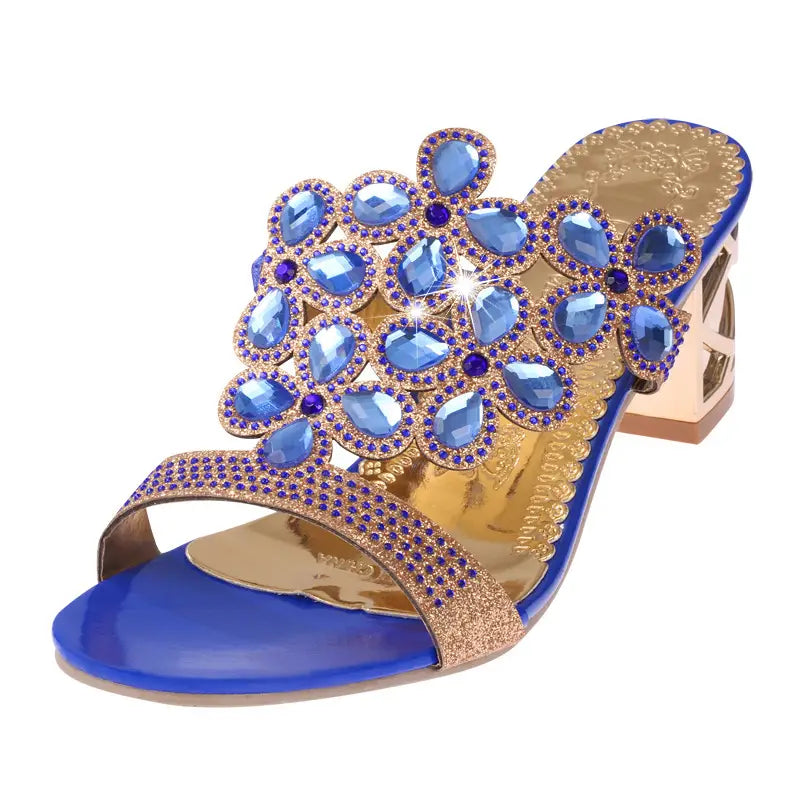 blue and gold embellished open-toe rhinestone high heel sandal featuring a floral design with blue teardrop crystals and smaller purple rhinestones