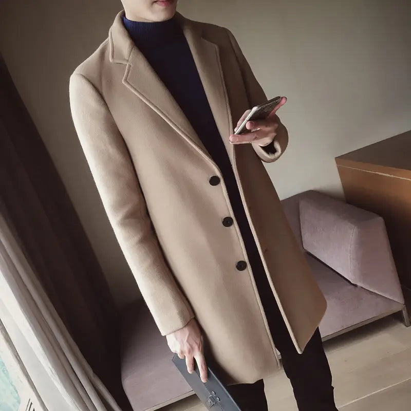 beige woolen mens slim trench coat in korean style featuring a double-breasted design with black buttons.