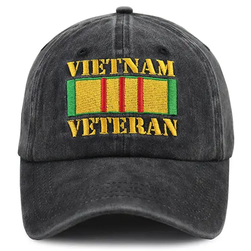 Dark gray denim-style Vietnam veteran embroidered baseball cap with gold thread text and a colorful ribbon patch featuring green yellow and red stripes.