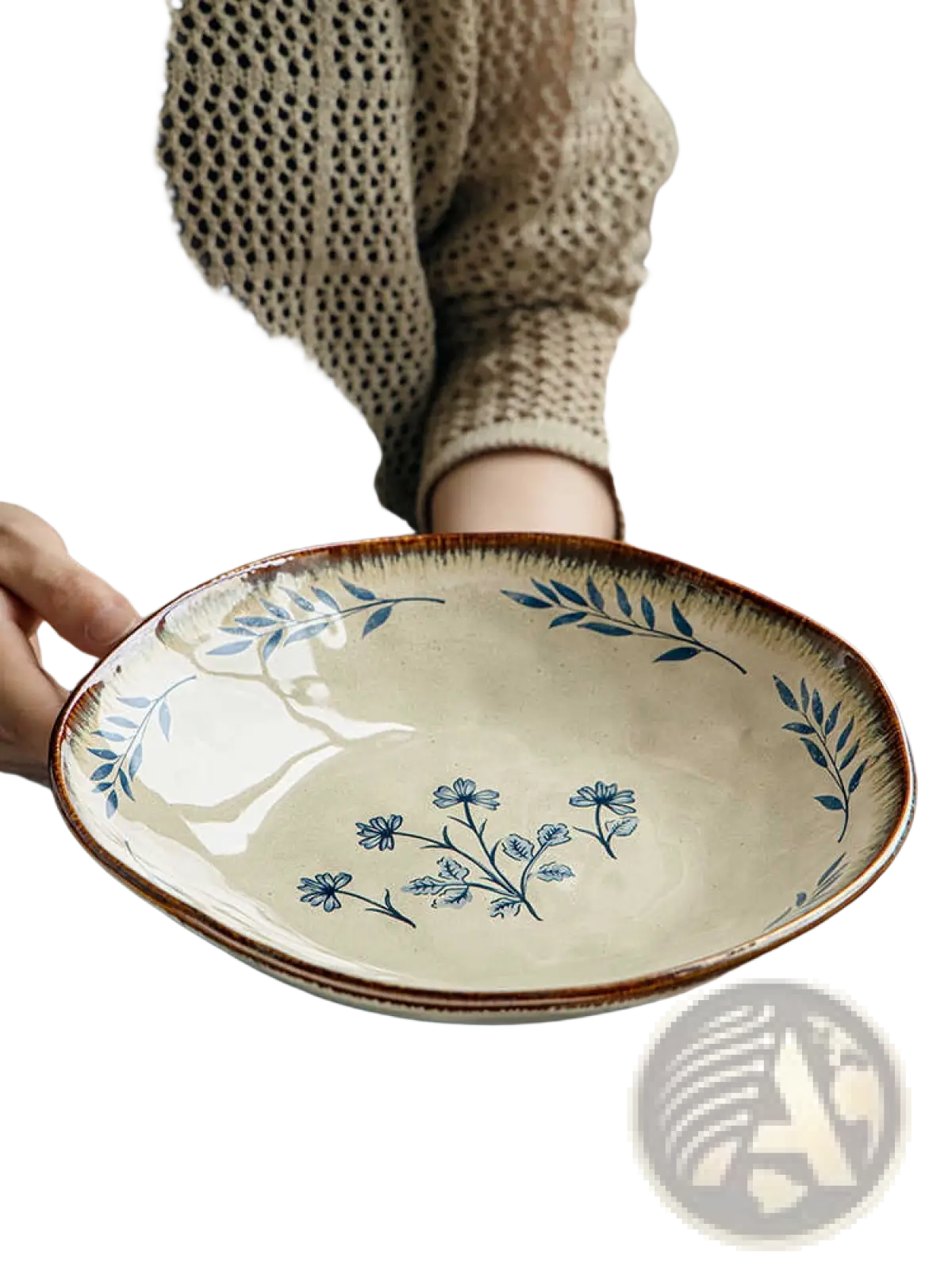 A cream-colored 9-inch ceramic deep plate with a rustic brown rim and delicate blue leaf floral pattern