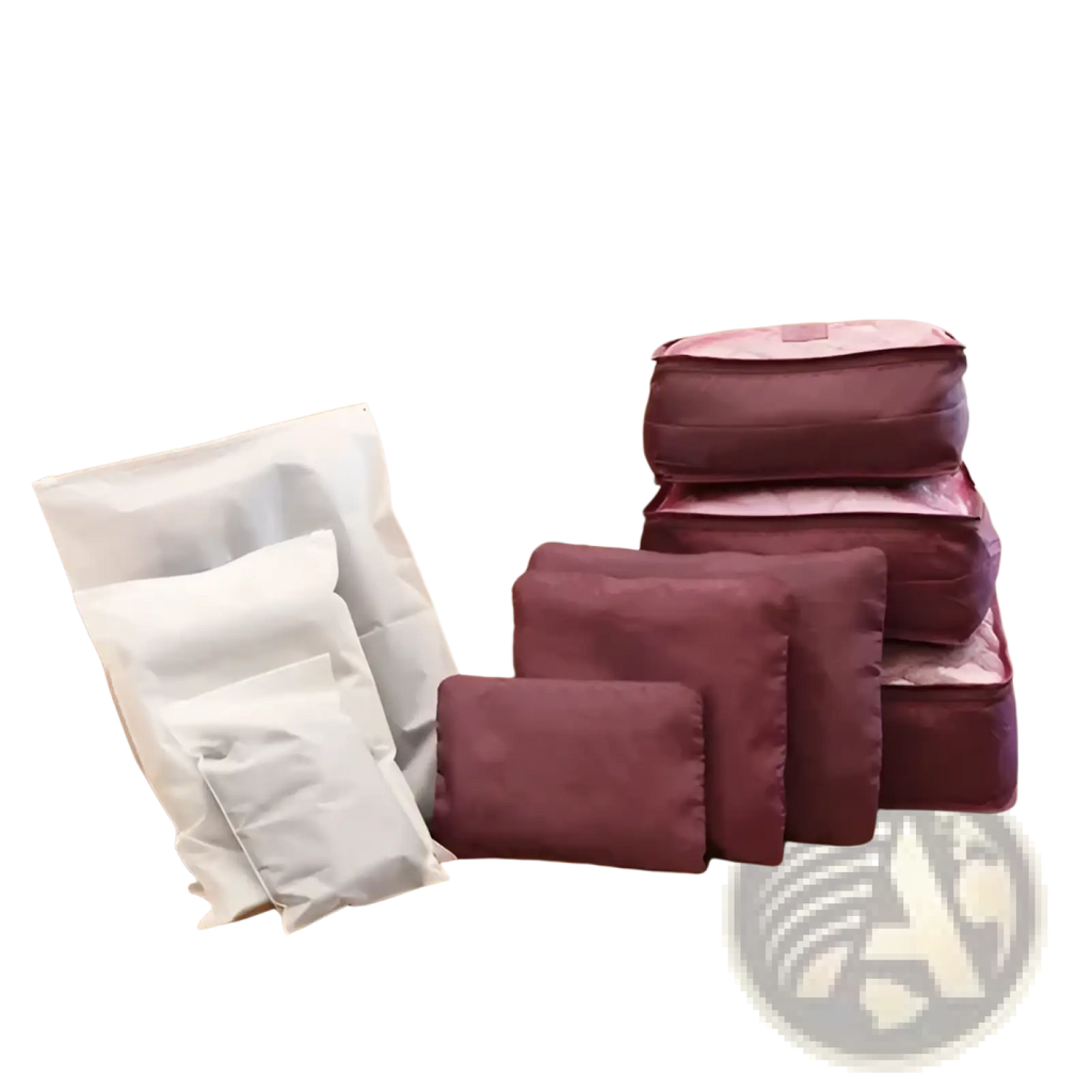 Set of maroon and white fabric packing cubes in a 9 piece water resistant travel organizer set arranged on a couch