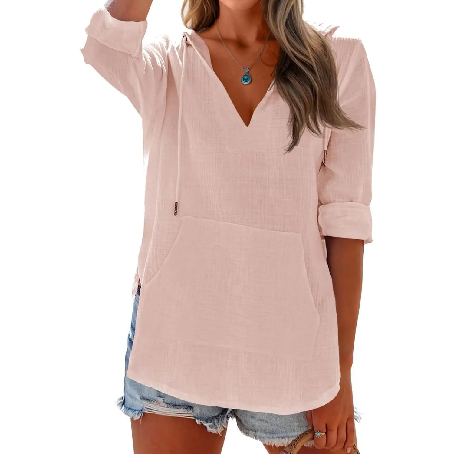 A soft blush pink women’s v neck cotton linen hooded pullover with pockets featuring a lightweight linen hoodie-style top design and rolled-up sleeves.