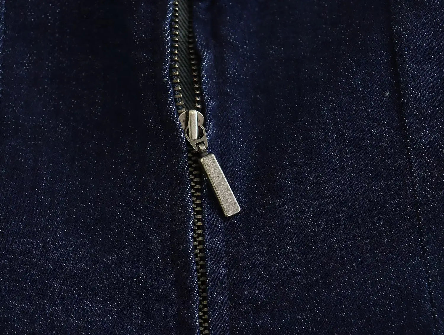 silver zipper pull on dark blue denim detail of a high neck navy velvet zip front maxi dress