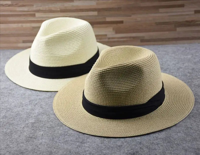 Beige straw fedora hat with a black ribbon band designed for foldable sun protection for men.
