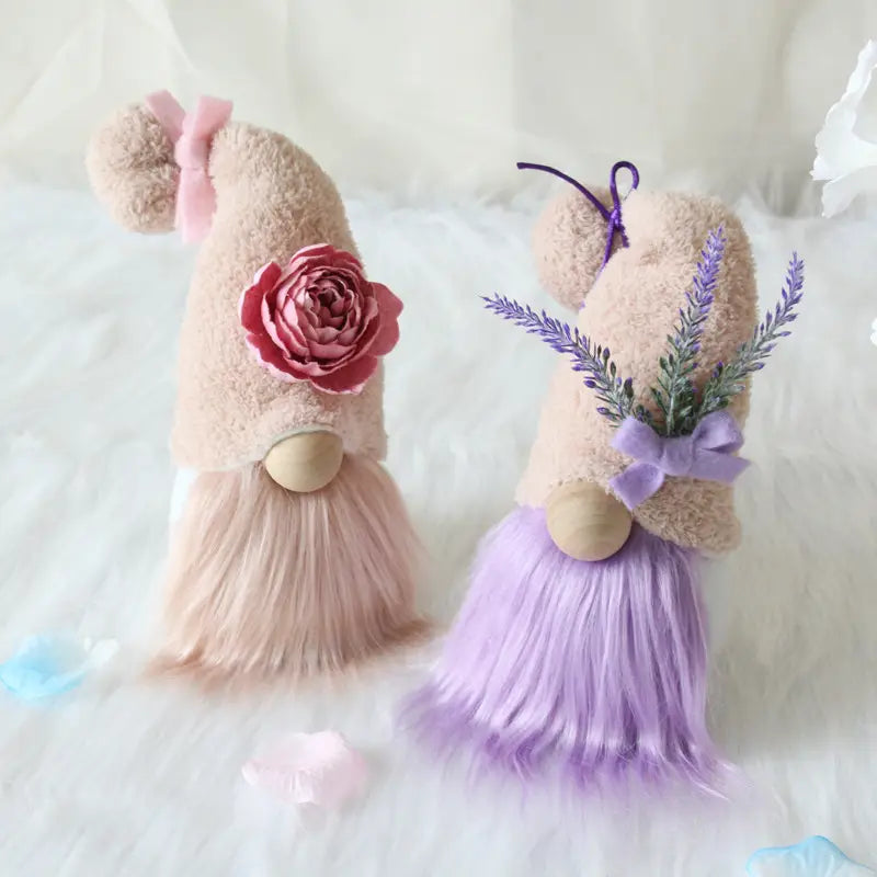 Two plush gnome dolls desktop ornaments featuring a pink rose on one and lavender sprigs tied in a bow on the other.