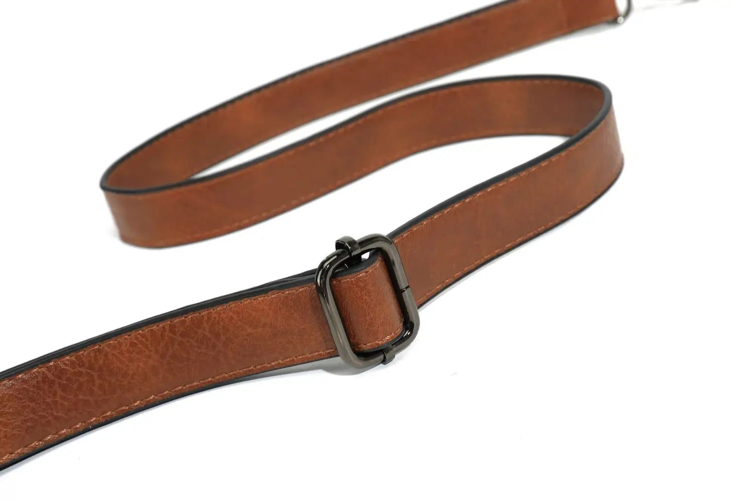 brown leather strap with a black metal buckle on a large capacity leather tote bag with shoulder strap