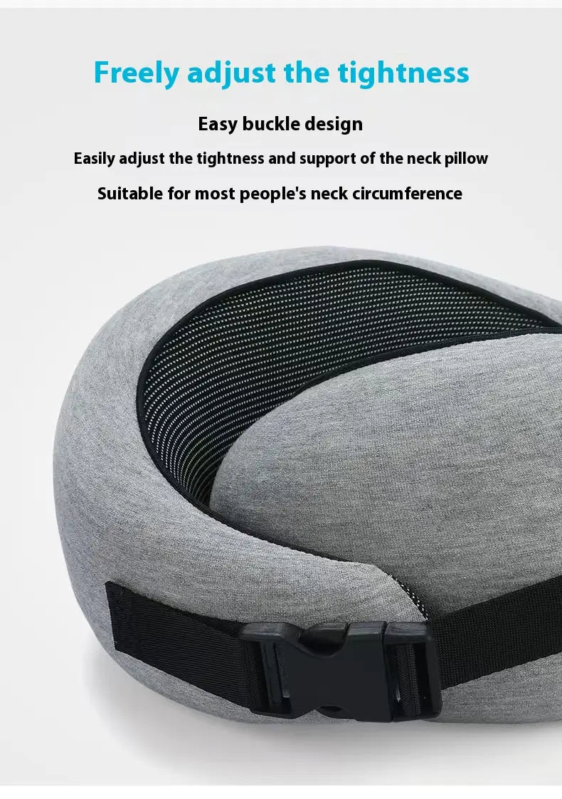 Gray memory foam travel neck pillow with adjustable black strap and buckle designed for ergonomic support during travel.
