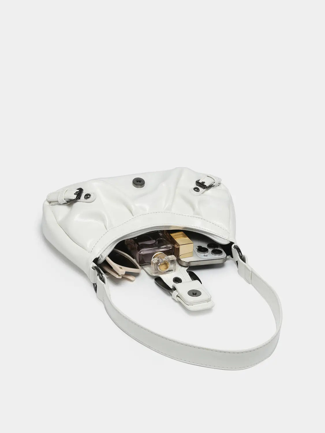 A sleek white patent leather vintage leather shoulder bag with black hardware accents and buckle details featuring a curved minimalist design.