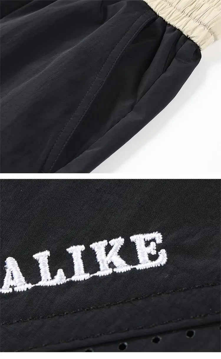 Shorts en nylon décontractés pour hommes, coupe droite, noirs, avec une ceinture élastique beige et une inscription « alike » brodée de couleur blanche.