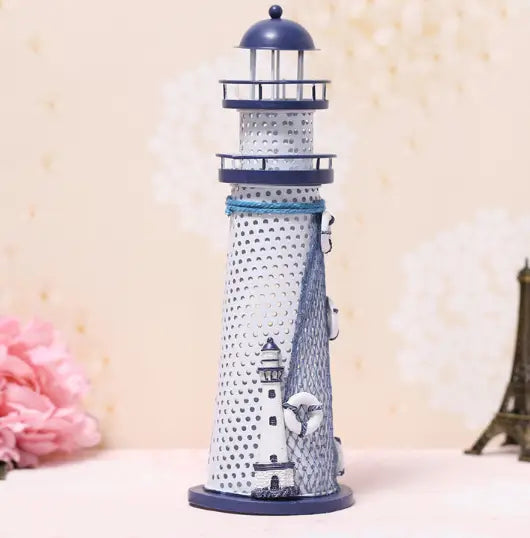 Mediterranean lighthouse garden statue decor featuring a white perforated body with navy blue accents and decorative rope wrapping around the midsection.