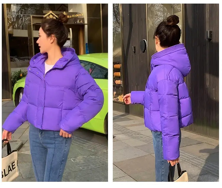 Women hooded short down jacket in vibrant purple with a quilted design and insulating material for cold weather.