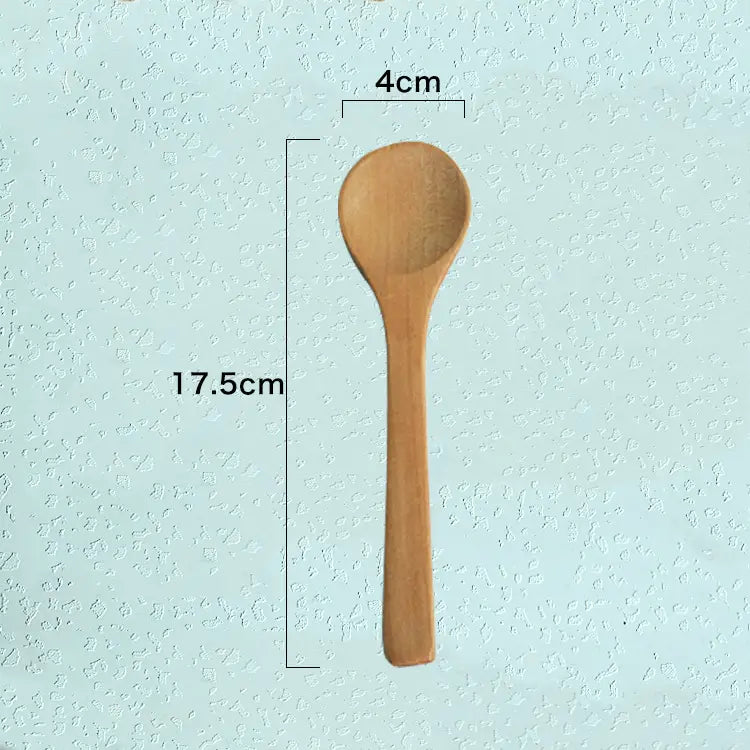 A smooth light brown wooden spoon with a rounded bowl and slender handle from a natural eco-friendly kitchen utensils wooden spoon set.