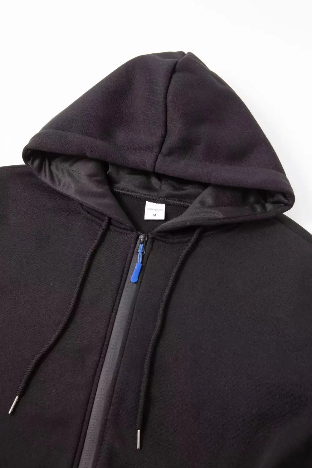 Sudadera deportiva con cierre para hombre en tallas grandes en negro, con tirador de cremallera azul a contraste y cordones a juego para uso atlético