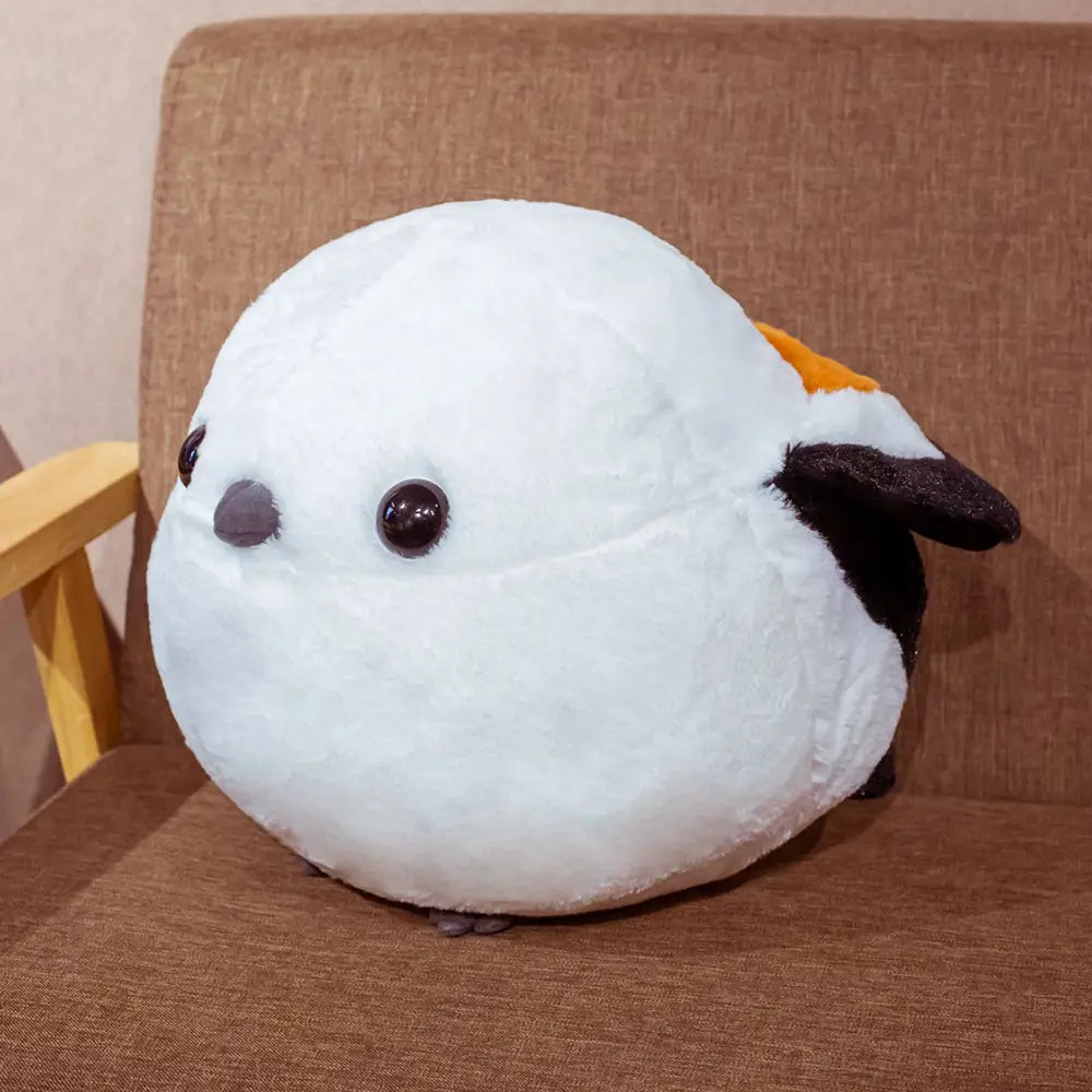 A soft plush sparrow bird toy featuring white fur, black eyes, a gray beak, and orange and black wing accents.