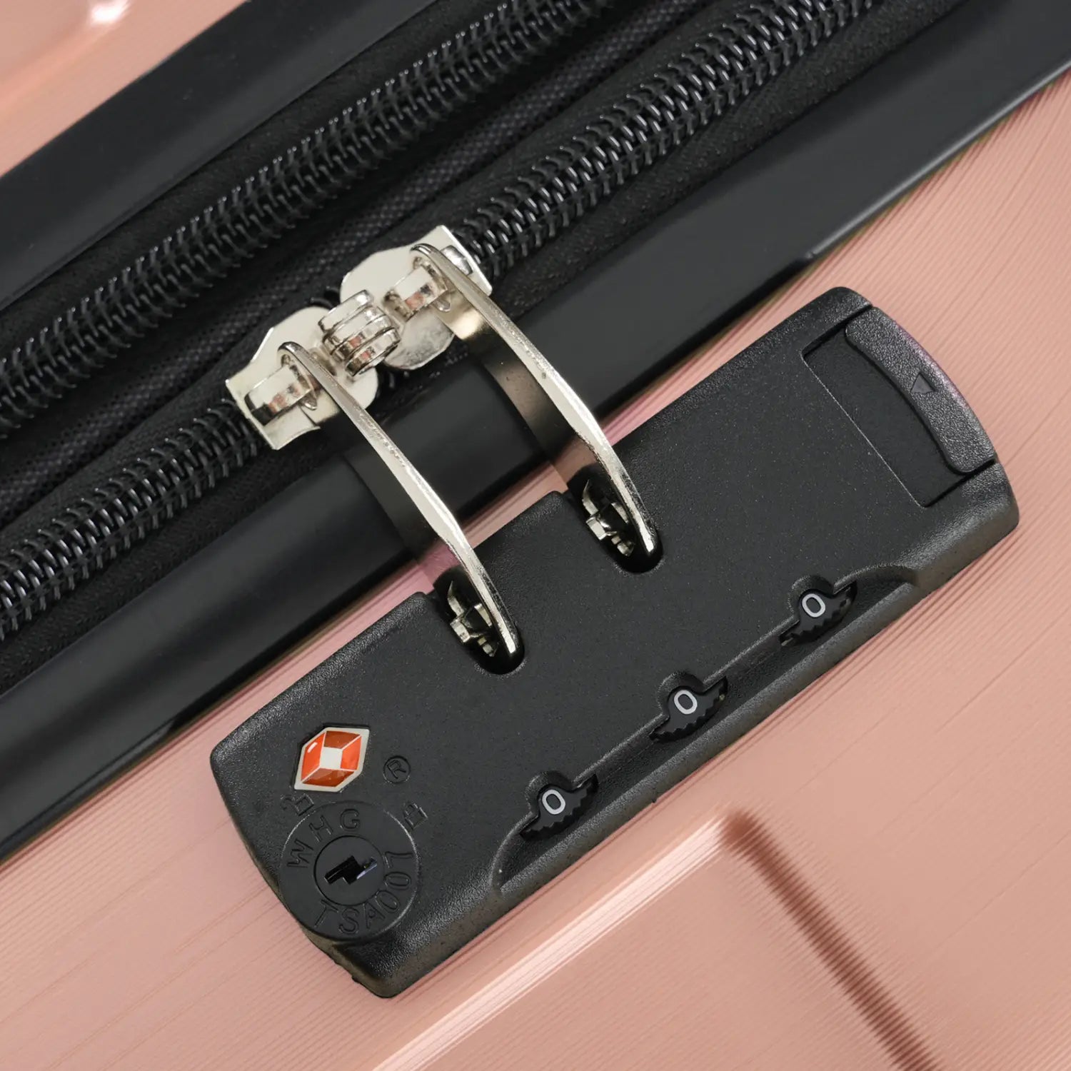 rose gold 28 inch expandable hardshell spinner suitcase featuring a black combination lock with silver metal components and an orange diamond-shaped logo on a pink suitcase zipper.