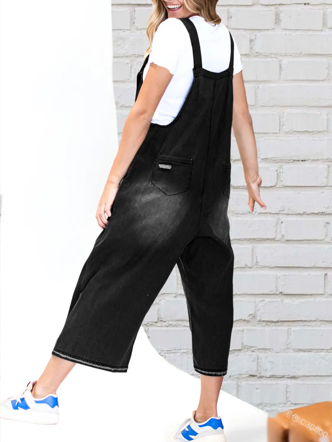 Black denim overalls with wide legs and a relaxed fit featuring adjustable straps and distressed detailing for women.