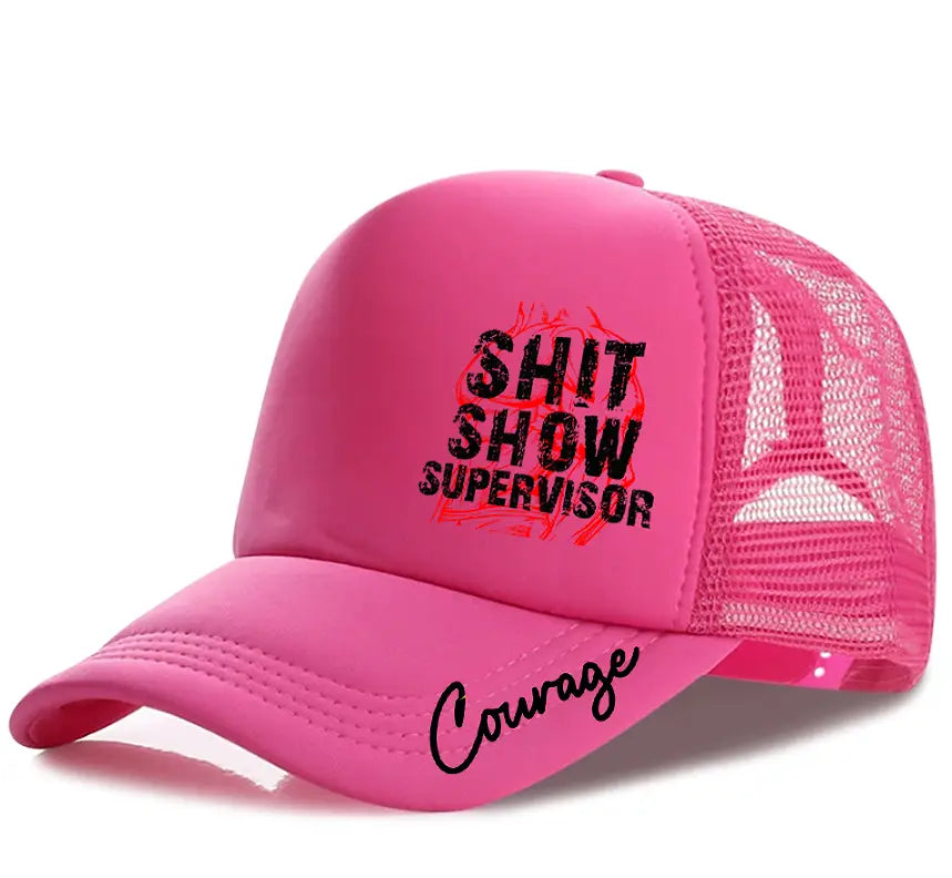 A vibrant pink novelty supervisor trucker hat with a mesh back featuring bold black text reading shit show supervisor and the word courage scripted in cursive along the brim.