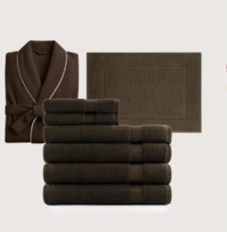 brown coral fleece bathrobe set featuring a plush brown bathrobe with white piping trim and matching dark brown towels and bath mat.