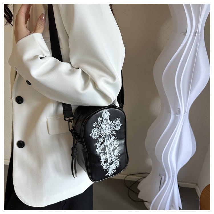 Black crossbody bag featuring intricate white embroidered floral and ornate cross design from the embroidered Halloween floral and pumpkin crossbody bags collection.