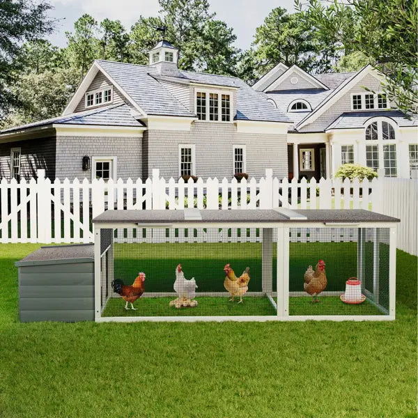 Gray and white wooden chicken coop with a slanted roof wire mesh sides and an attached storage box shown from the back side for a walk-in hen house with nesting box.