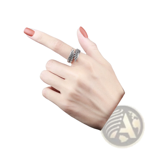 Silver-toned 925 sterling silver detailed angel wing ring with an intricately twisted band worn on a finger