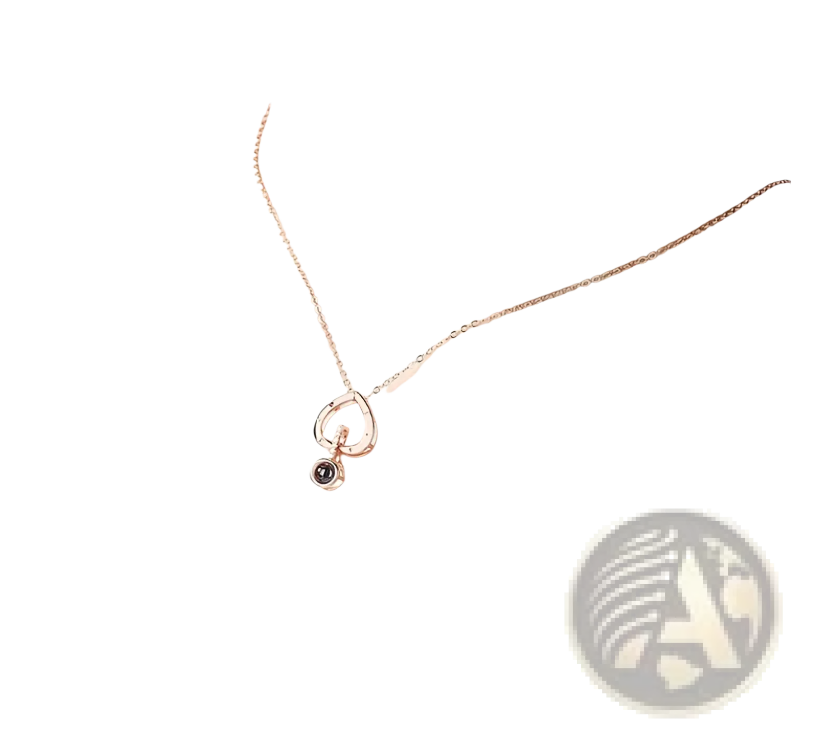 A delicate 925 sterling silver rose gold necklace with an open circular pendant and small black gemstone accent
