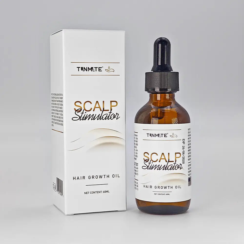 Aceite para el cabello de menta tunm.te para el cuidado del cuero cabelludo y el crecimiento, presentado en un frasco de vidrio ámbar con tapa cuentagotas negra, junto a su embalaje blanco.