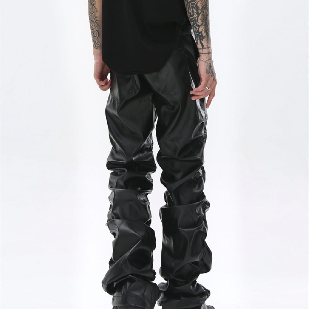 men’s black ruched glossy faux leather tapered pants featuring a sculptural design.