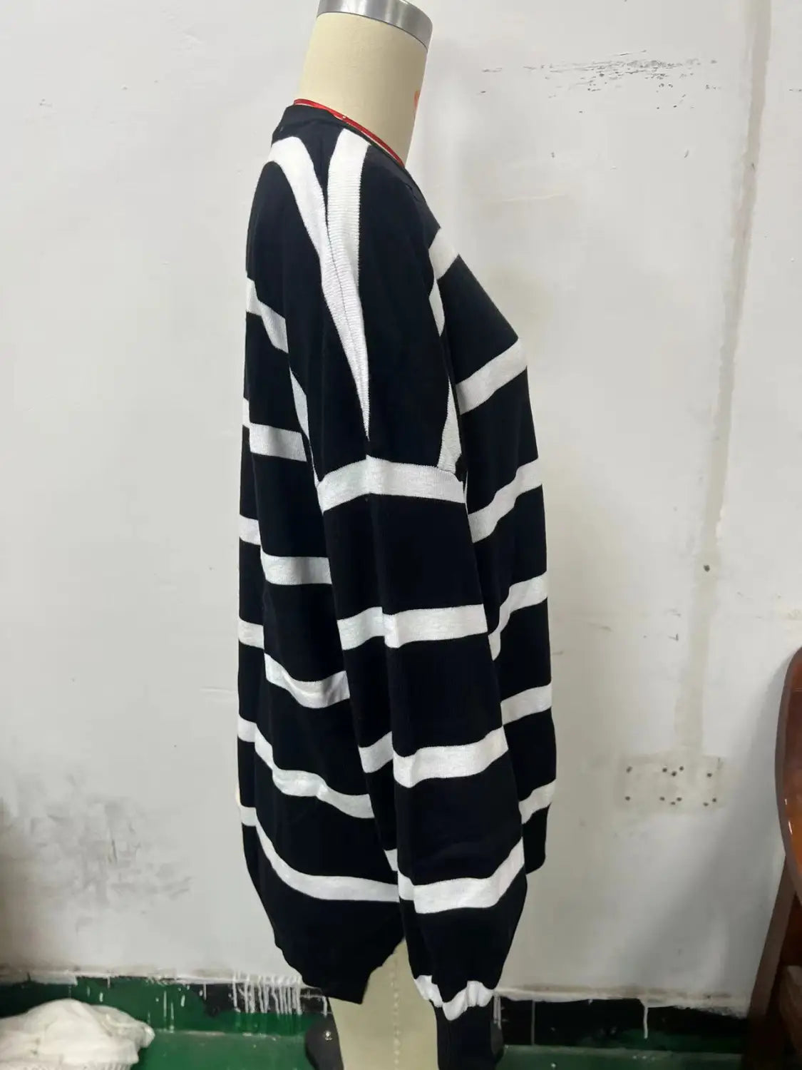 black and white horizontally striped women’s oversized split color knit sweater with ribbed neckline and cuffs