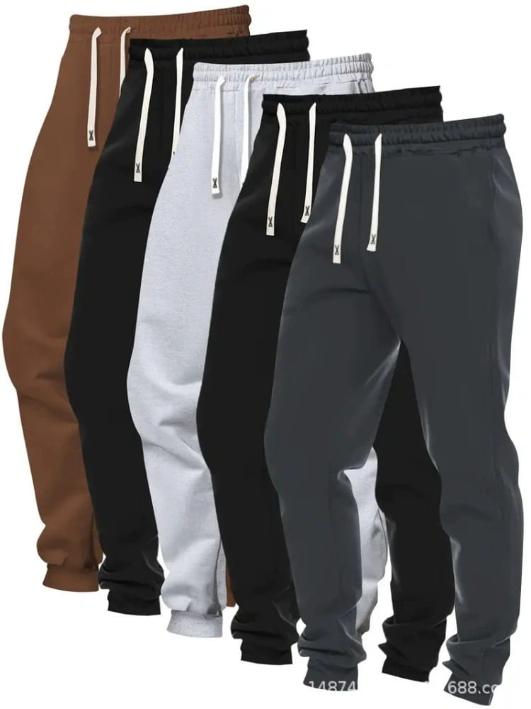 Five pairs of men’s casual jogger pants in brown black white and gray with matching drawstrings and a small x logo in a 5-pack solid set.