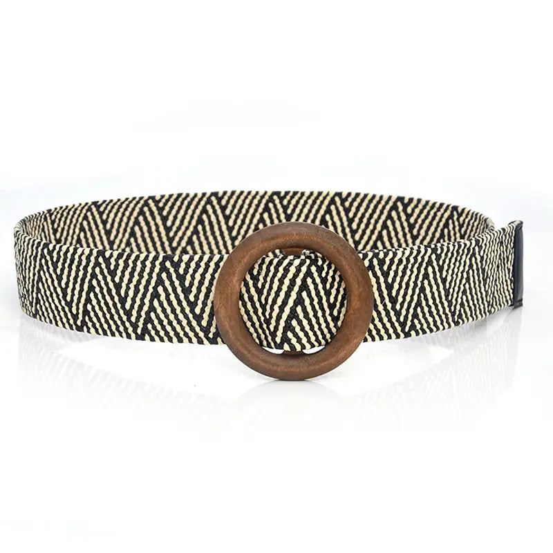 Woven elastic belt with a black and cream herringbone pattern and a rustic wooden circular buckle.