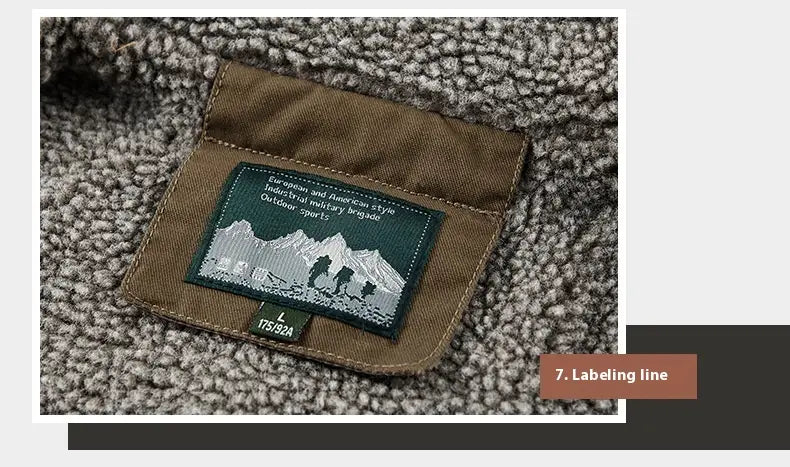 Brown fabric label with dark green embroidered mountain and hiker patch stitched onto the textured gray fleece interior of a mens fleece lined winter cotton jacket.