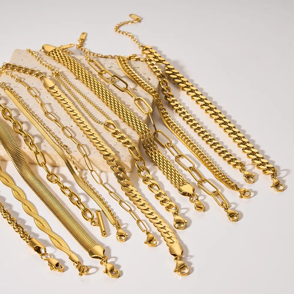 A collection of 18k gold pvd plated stainless steel chain link bracelets featuring various styles including curb, box, and snake link designs.