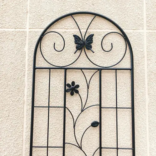 Black wrought iron garden trellis featuring decorative rustproof butterfly and flower motifs measuring 71 inches in a 2 pack set.