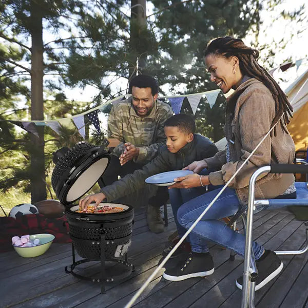 Black ceramic 13 inch kamado charcoal grill with a round dome shaped lid and a sturdy base.
