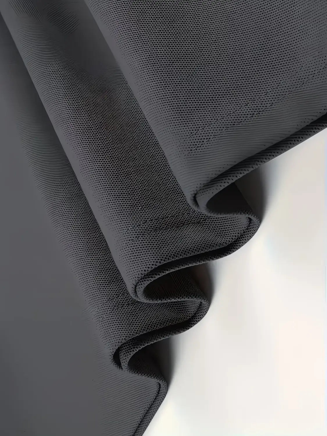 a dark gray textured yoga mat with a subtle grid pattern displayed alongside a mens slim fit striped polo shirt.