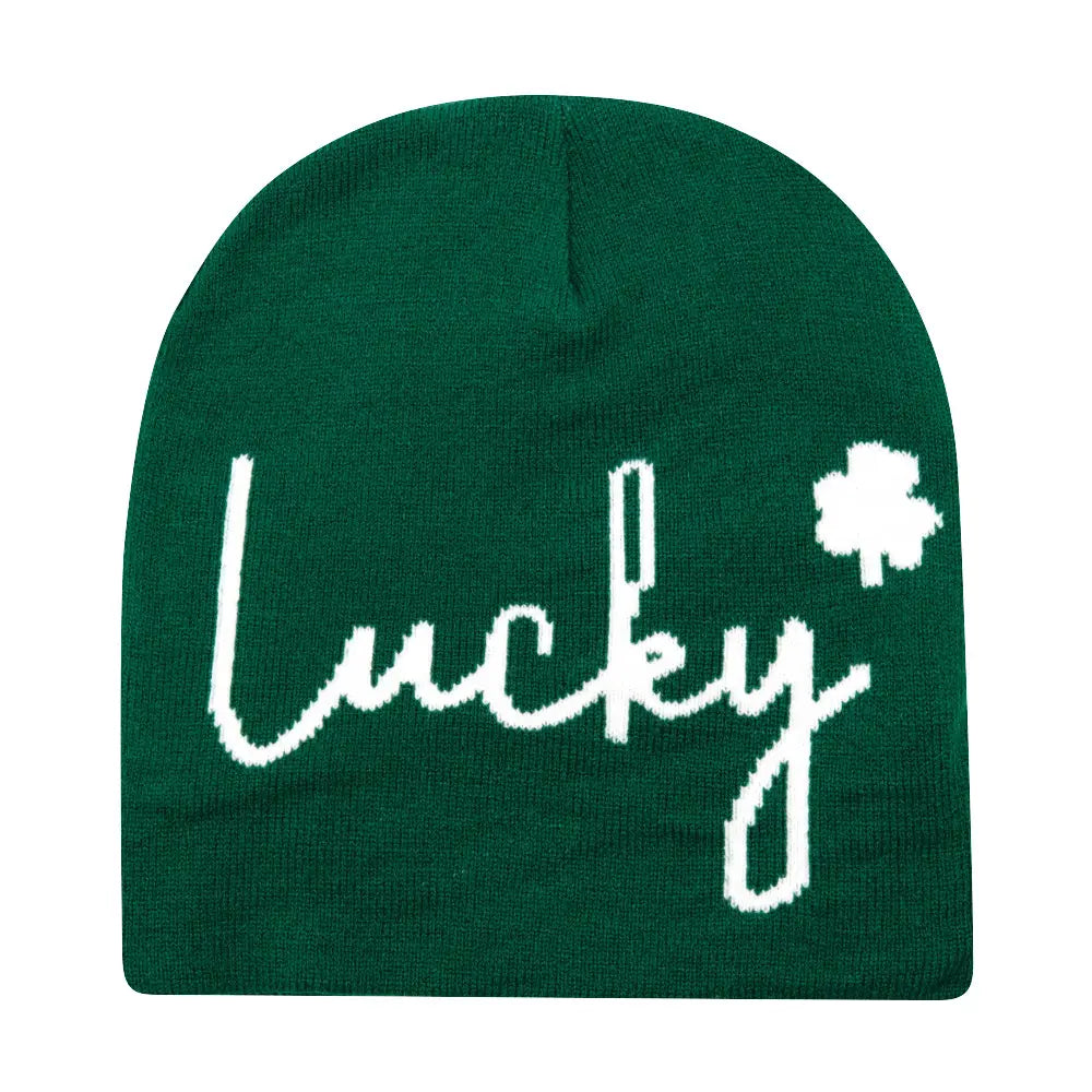Deep green knitted beanie made of warm knit material featuring the word lucky in white cursive script with a small shamrock symbol for winter use.