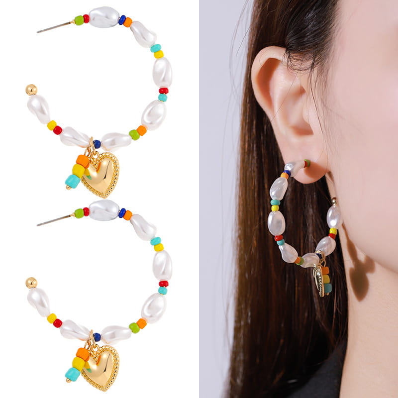 Rainbow-beaded pearl hoop earrings with a gold heart charm from the layered gold butterfly and pearl jewelry set for women.