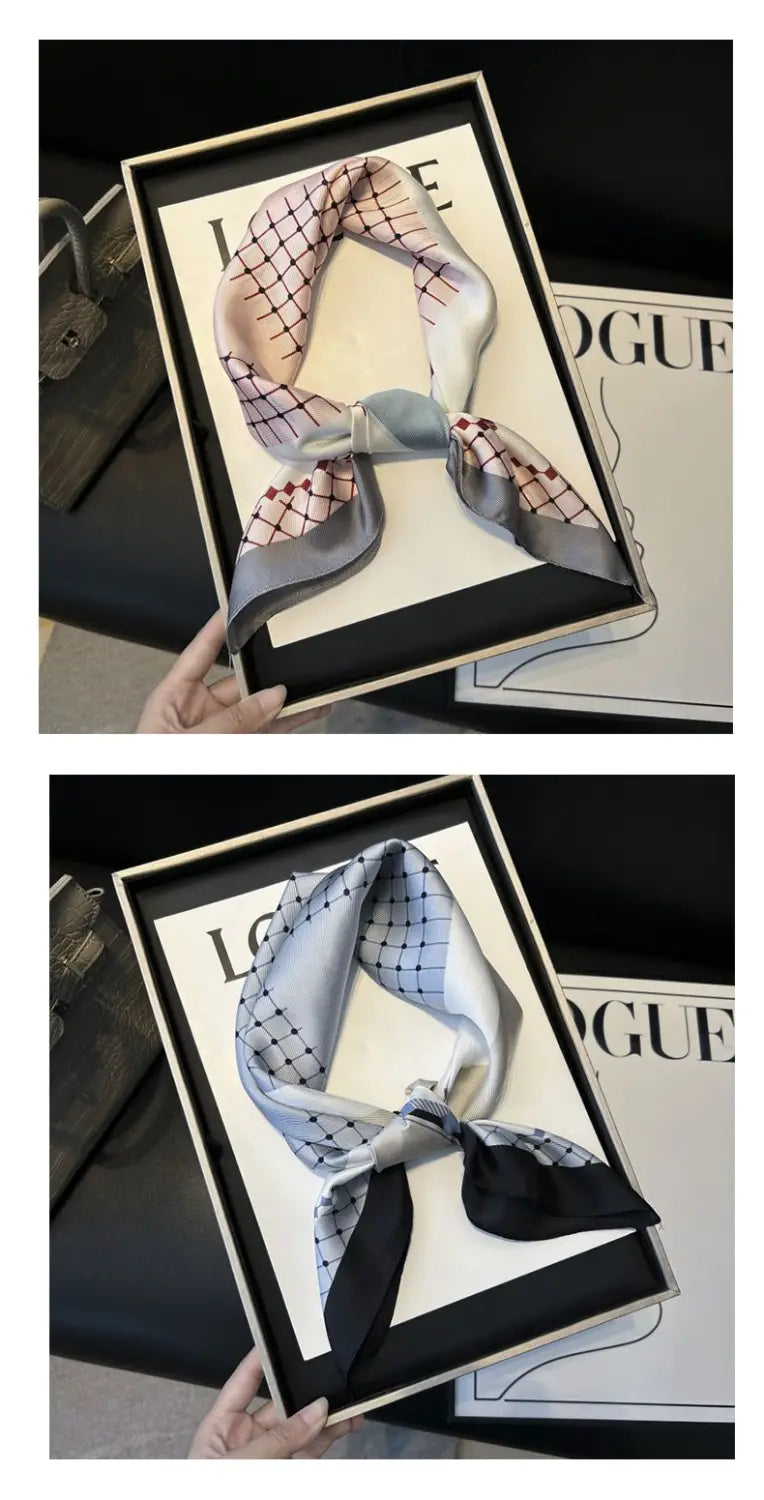 A delicate pink and gray checkered twill silk look square scarf elegantly tied in a bow and presented in an elegant black-framed gift box.