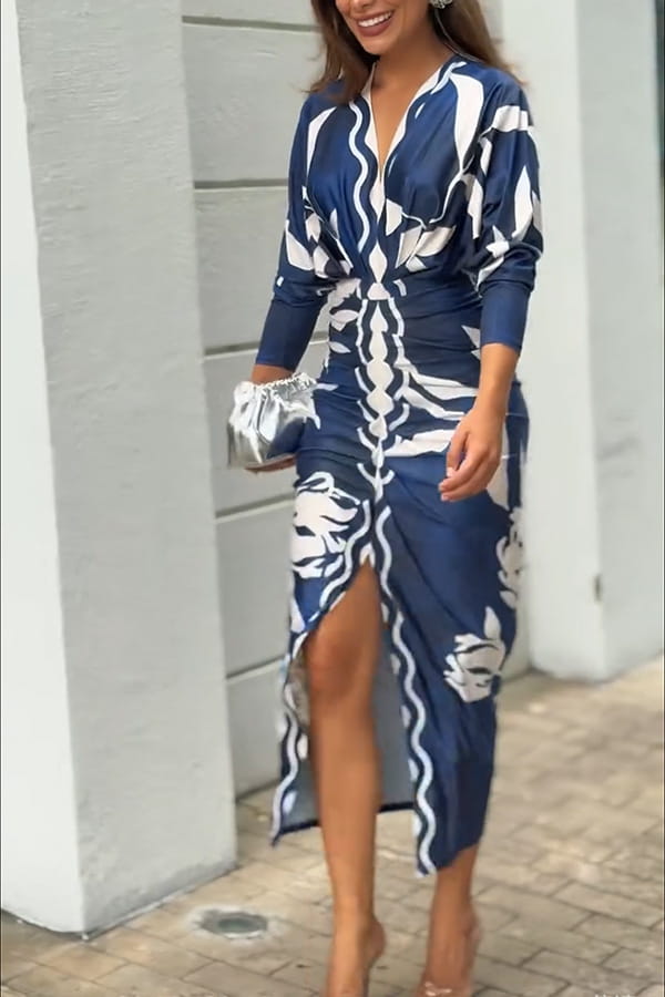 A navy blue and white printed v-neck geometric wrap midi dress with long sleeves and a high slit.